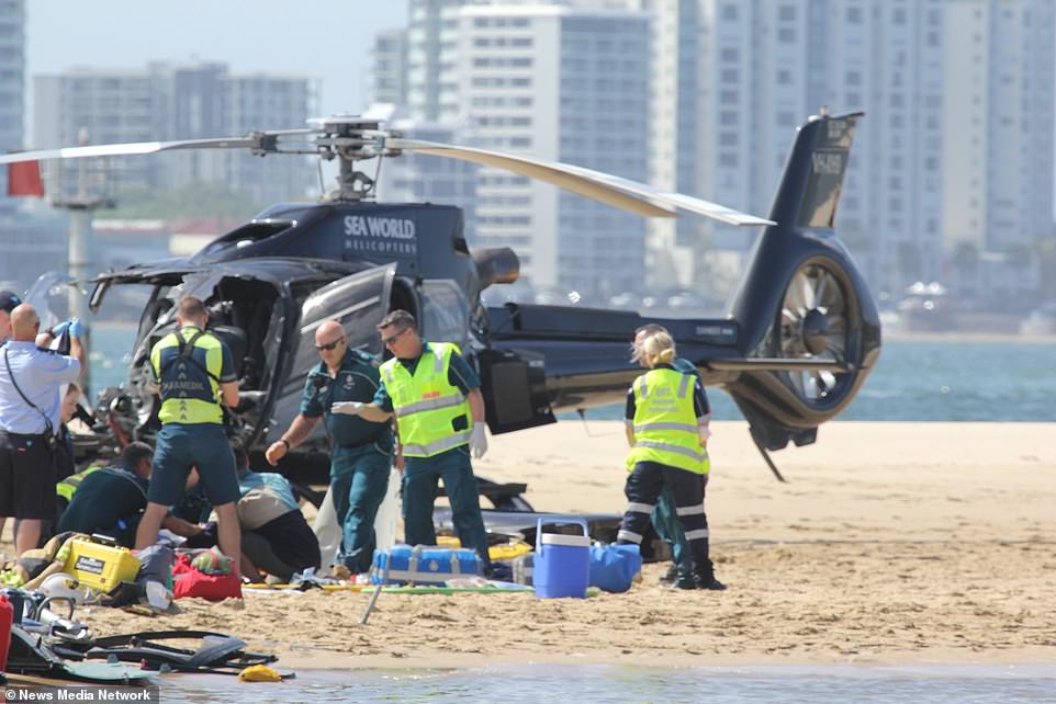 Paramedics and police officers at the scene Monday afternoon (pictured)