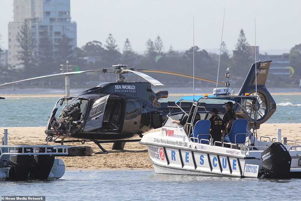 Marine Rescue ran onto the sandbar, seen in front of a helicopter with the Sea World logo