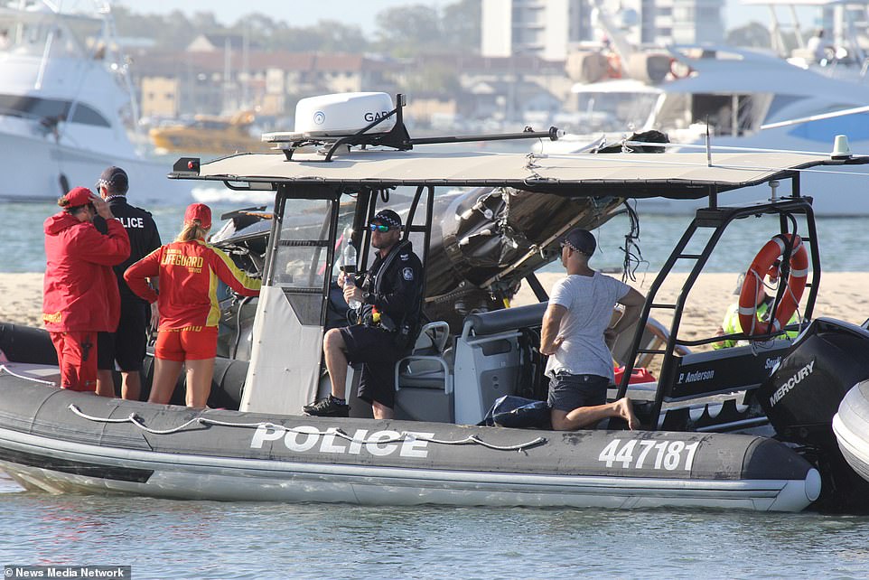 Lifeguards and police aboard one of several boats that arrived at the scene