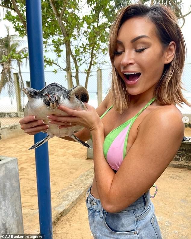 Making new friends: AJ pictured at a turtle hatchery in Sri Lanka