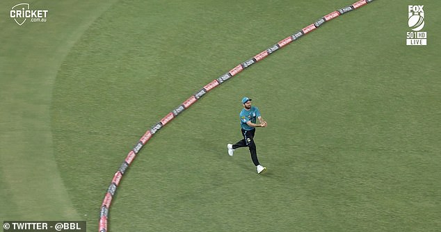 Before stepping back over the boundary line to finally grab the ball and complete the catch.