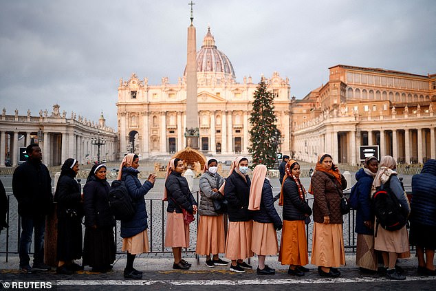 People queued outside the basilica to be able to enter and pay their respects to Pope Benedict