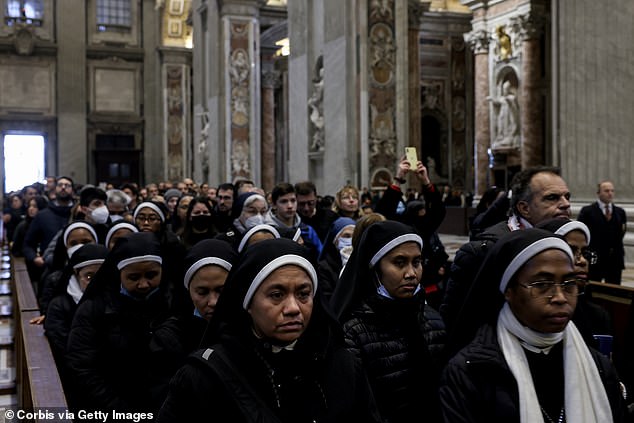 Nuns and other members of the puli queue to view the body of Pope Benedict XVI during the three days of rest.