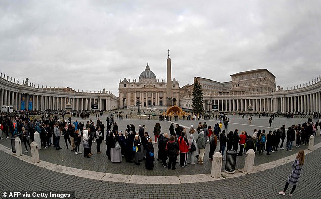 By mid-morning, the queue to enter the basilica snaked around St. Peter's Square as people waited to pay homage to the former pope.