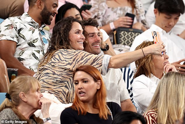 Newlywed Matty 'J' Johnson and Laura Byrne took beaming selfies during the match, with Laura holding out her camera for a nice snap.  both in the photo