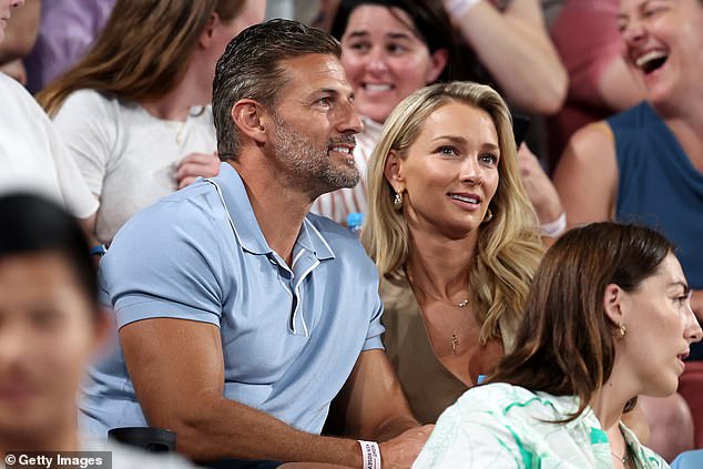 Glamorous bachelor couple Tim Robards and his wife Anna Heinrich sat next to each other, with Anna looking gorgeous in an olive green top.  both in the photo