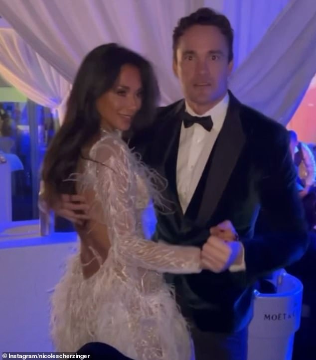 In love: Nicole celebrated the new year with her fiancé Thom Evans.  who also joined in on the fun as she shared a dance with the hitmaker