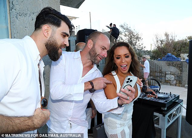 Fred Schebesta (in the center of the photo) mixes with his guests next to the turntables