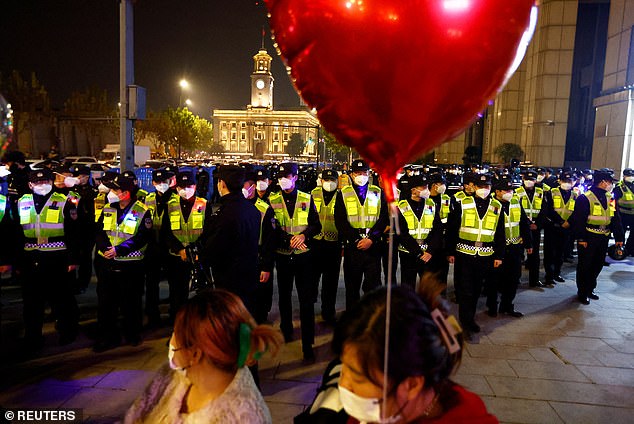 Police guard an area to prevent mass gatherings during New Year's Eve celebrations in Wuhan