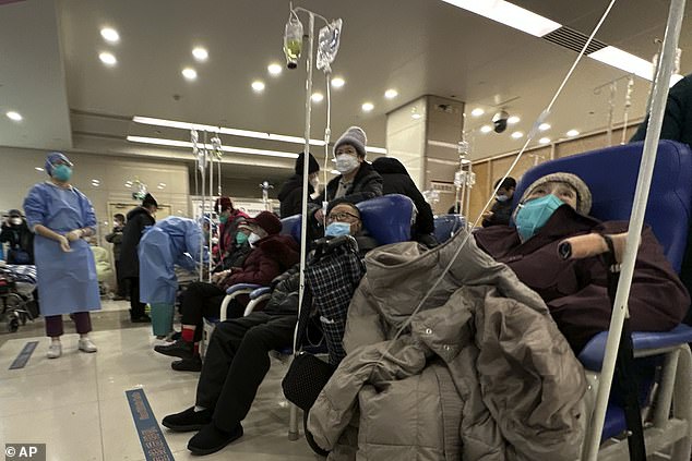 Elderly patients rest in a cordoned off area to be given intravenous drips at a Beijing hospital.