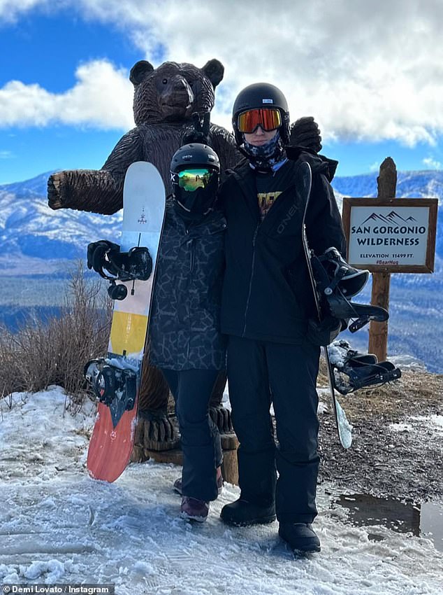 Ready to go: Another snap showed Lovato and her love on top of a San Gorgonio Wilderness mountain as they got ready to go snowboarding