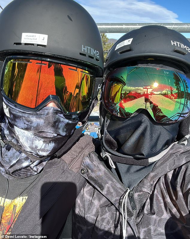 Coordination: The duo showed off their stylish dark snowsuits, goggles and helmets.