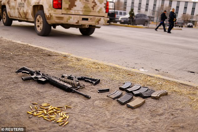 Guns and bullets are seen in front of the Cereso No. 3 state prison that were recovered by security forces