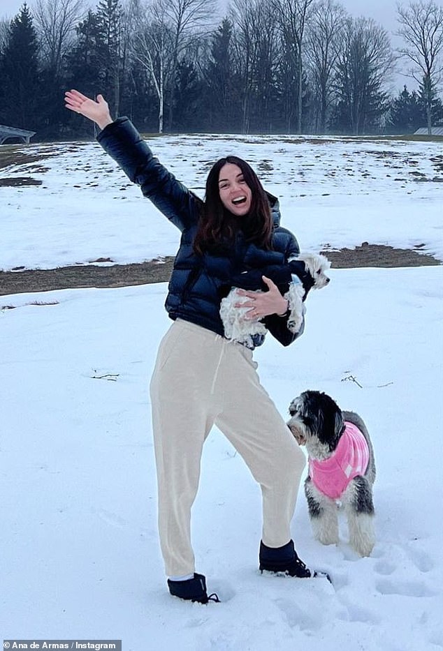 Outside in the Snow: Later, she dressed in a cropped black puffer jacket and black boots as she stepped out into the snow with her dogs