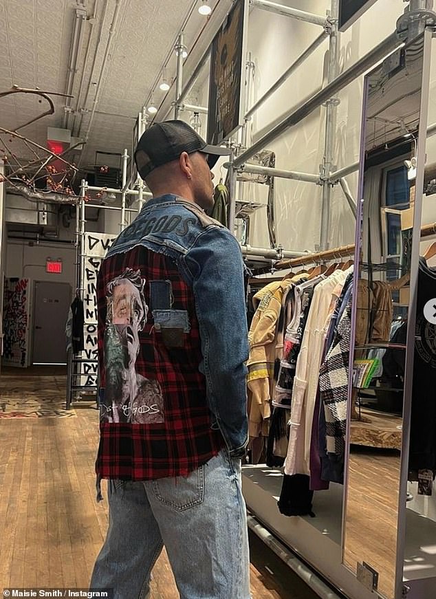 Cool: He also posted a photo of Max looking at himself in the mirror at a fancy clothing store, wearing a jean shirt and plaid patches with a baseball cap.