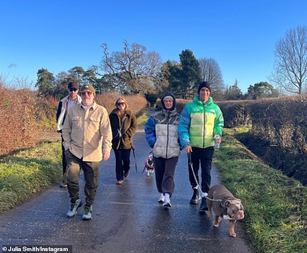 Out and about: Maisie's family joined the couple for a walk with the dog on a cold sunny day