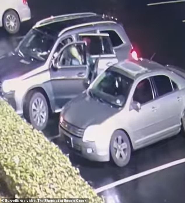 The men could be seen grabbing the woman as she got into her own car.