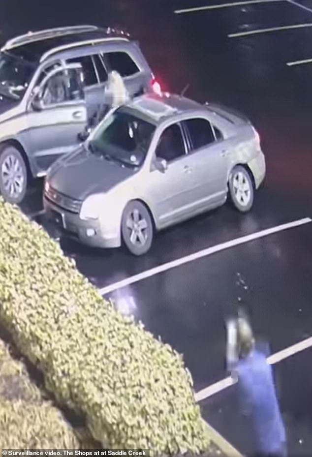 The image shows a bystander, who was armed, pointing his gun trying to scare off the suspects while the horrified victim was able to escape from her attacker and run to safety.