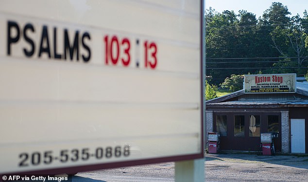 A custom gun and bow shop is seen across the street from the Mercedes Drive Church of Christ in Vance, Alabama, in a file photo.