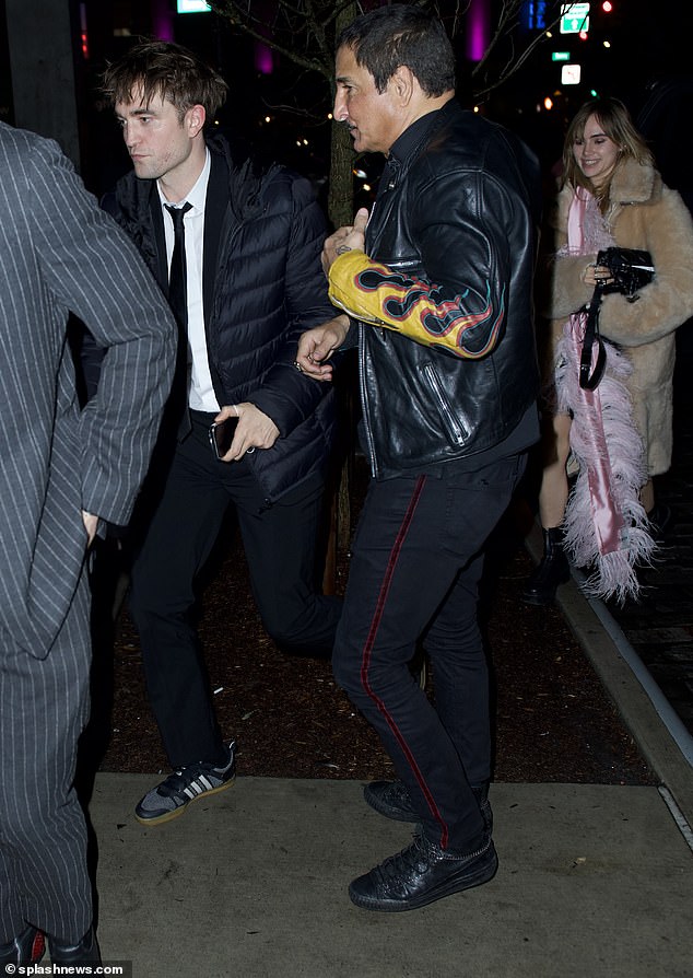 Celebrate: For her night out, Suki rocked the same fuzzy coat, added a pink furry scarf and boots, while carrying a black bag