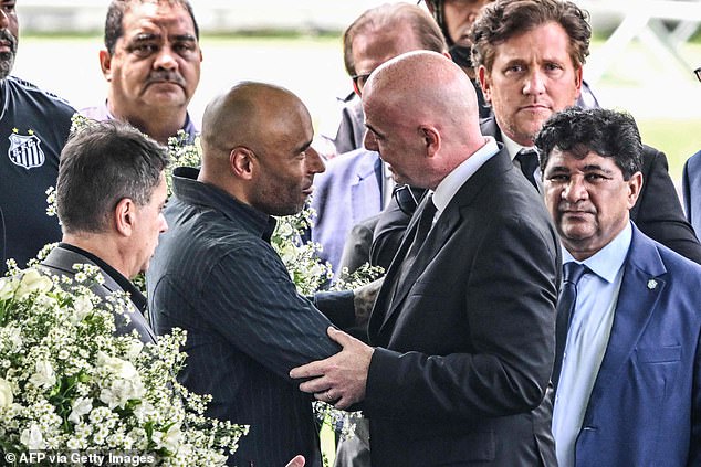 Infantino (right) greets the son of Brazilian football legend Pele, Edinho (left), during his wake at the Urbano Caldeira stadium in Santos, Sao Paulo, Brazil on January 2