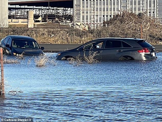 Meanwhile, more excessive rain could hit California again on Wednesday after the northern part of the state slumped with widespread flooding over the weekend.  A car is seen submerged in water in Sacramento