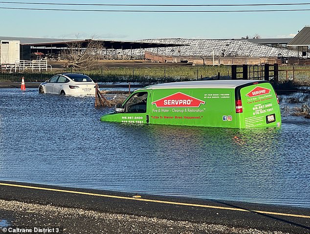 Two more cars were seen submerged in water as power went out to more than 170,000 homes over the weekend.