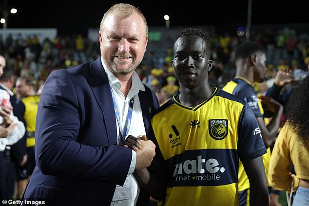 Central Coast Mariners chief executive Shaun Mielekamp (left) shakes hands with Garang Kuol after the youngster played his last game for the club on New Year's Eve before heading to the UK to play in the EPL giant, Newcastle.