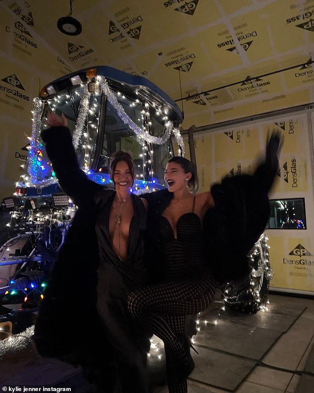 Party time: She and Stassie raised their arms and smiled next to a snowplow that was covered in Christmas lights at another time.