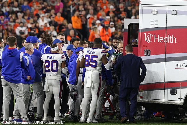 Bills players watch as Hamlin is taken to an ambulance and rushed to the hospital.