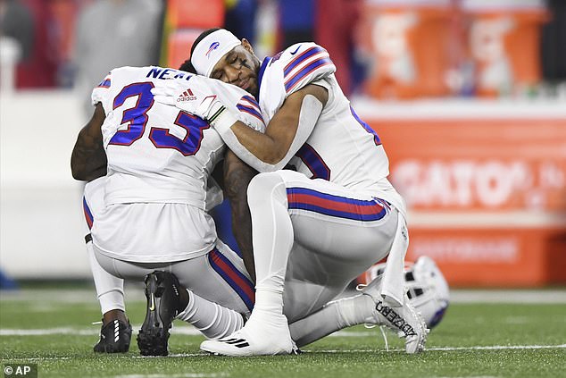 Bills cornerback Siran Neal (33) and running back Nyheim Hines (20) hug