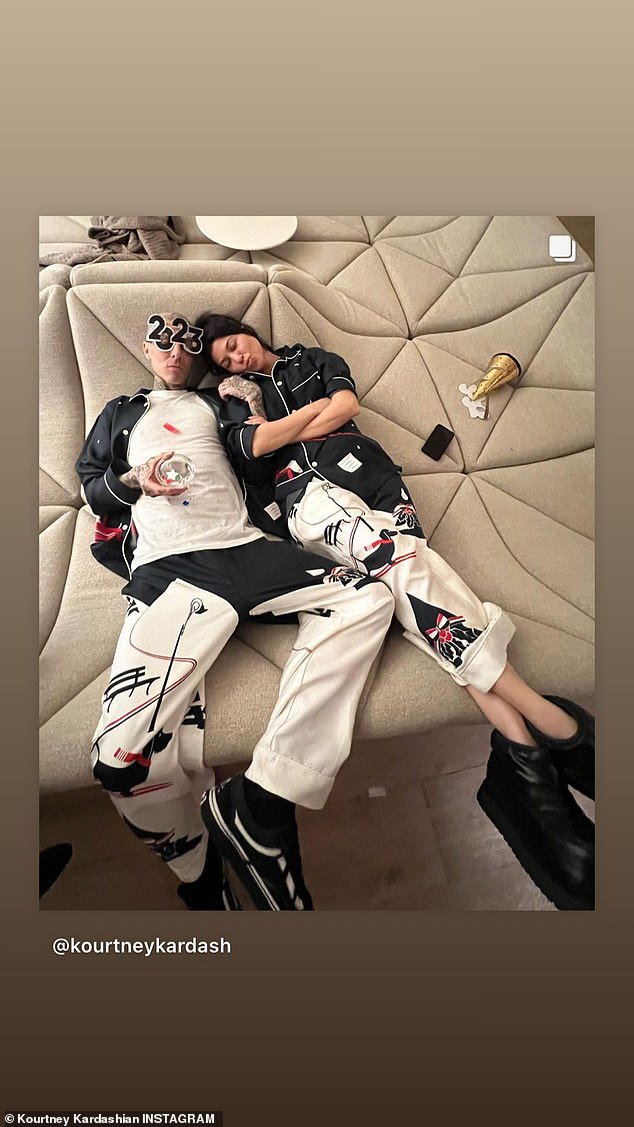 Staying chill: In another shot, Kourtney and husband Travis Barker reclined on a couch together wearing big 2023 novelty glasses in