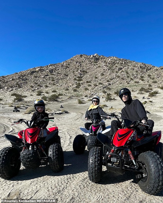 Riding together: The pair hopped on big ATVs alongside Travis later  A huge desert hill stretched into the clear blue sky.