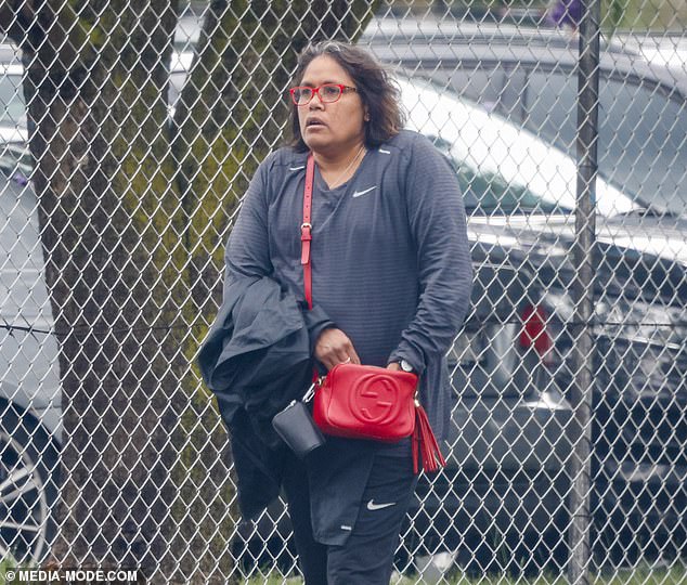 The former sprinter, 49, went for a cool casual look in a black Nike tracksuit which she paired with an $1800 Gucci bag and matching red sunglasses.