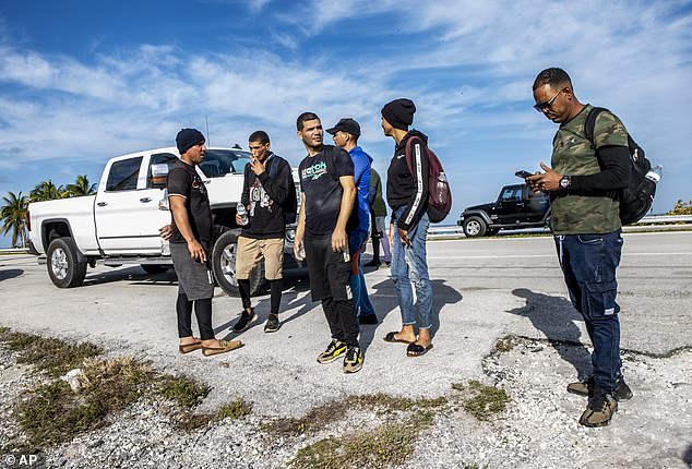 A group of Cuban immigrants were seen standing in the sun while standing in the middle of Duck Key, Florida.