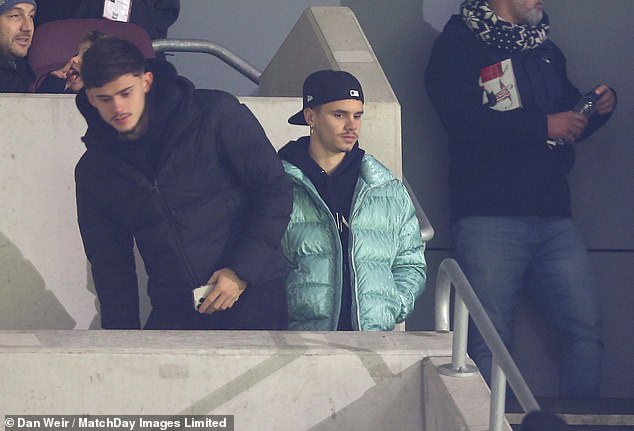 Game: The footballer, 20, who has been training with Brentford's B team in recent months in a bid to advance his career, was joined by a friend as he watched from the stands.