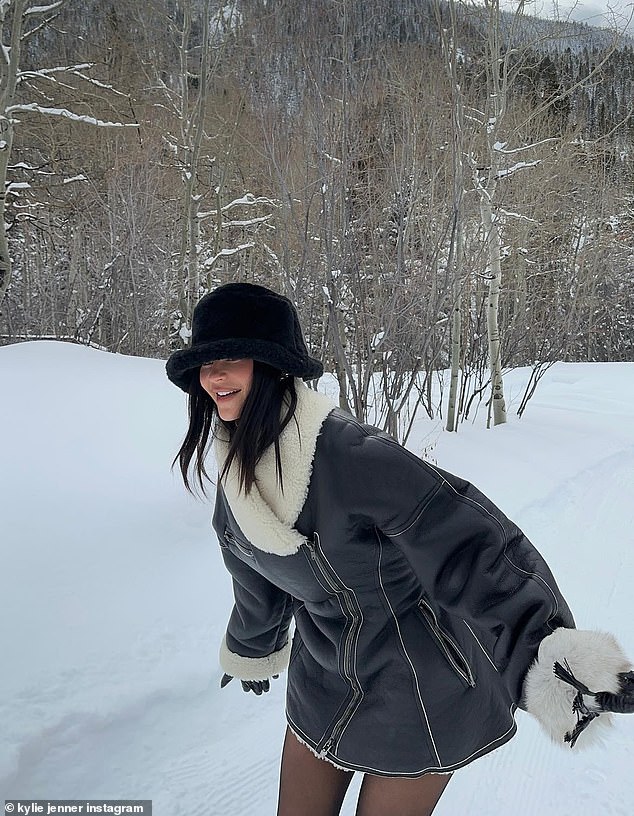 Don't slip: Kylie showed off her snowy best in black fur and leather jacket with white fur collar and cuffs as she rocked with both arms at her sides