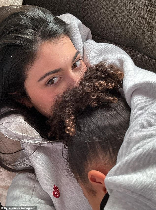 Baby mine: Kylie's daughter rested her head on her mom's chest as she lay back on the couch