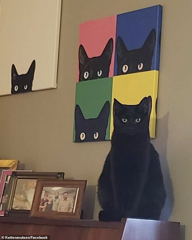 This cat blended in perfectly with a piece of art that hung behind him in this perfectly timed snap.