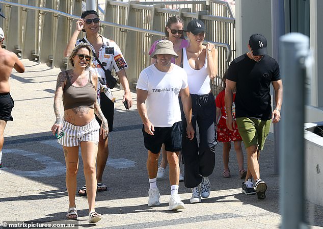 He added black shorts and a white Saint Laurent T-shirt, while shielding his head from the sun with a khaki bucket hat.