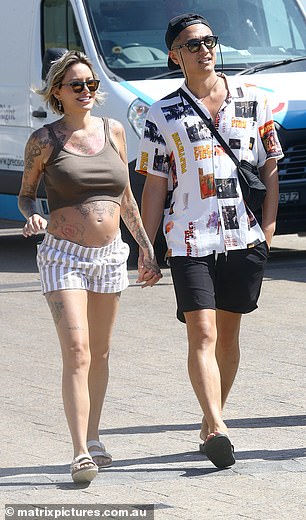 Meanwhile, Tina Louise showed off her burgeoning baby bump in blue and white striped shorts and a khaki top.