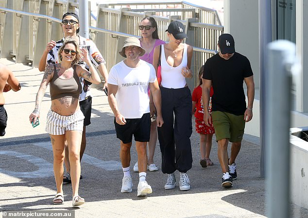 Tina added Birkenstocks and sunglasses, while her partner Sei Moon also looked hippie in black shorts, thongs, and a patterned open-neck shirt.