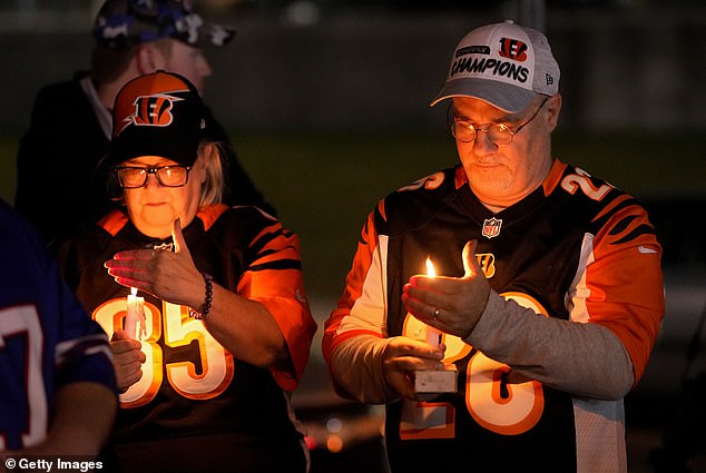 Fans gather for a vigil at the University of Cincinnati Medical Center for Buffalo Bills football player Damar Hamlin, who collapsed after making a tackle during a game against the Cincinnati Bengals on Monday in Cincinnati, Ohio.