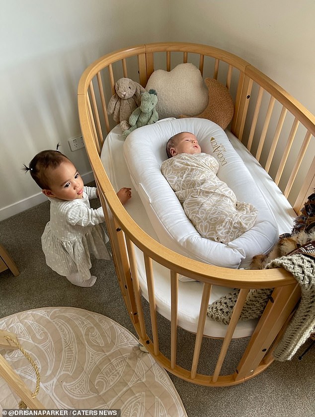 Shai, left, and River, in the crib, are just four months apart and are being raised almost like siblings.