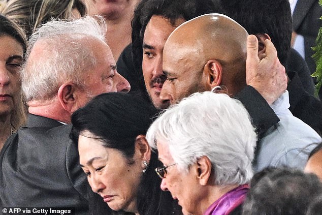 Brazil's President Luiz Inácio Lula da Silva (left) greets the late Brazilian soccer legend Pelé's son Edinho (right) during his wake at the Urbano Caldeira stadium in Santos, on January 3.