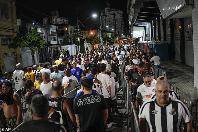 Soccer fans line up to attend the funeral of the late Brazilian soccer legend Pelé at the Vila Belmiro stadium in Santos, Brazil, early Tuesday, January 3.