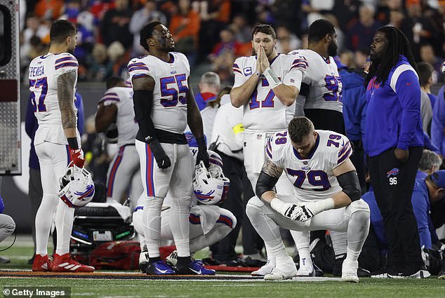 Both the Bills (above) and Bengals players were visibly upset when Hamlin received CPR on the field.