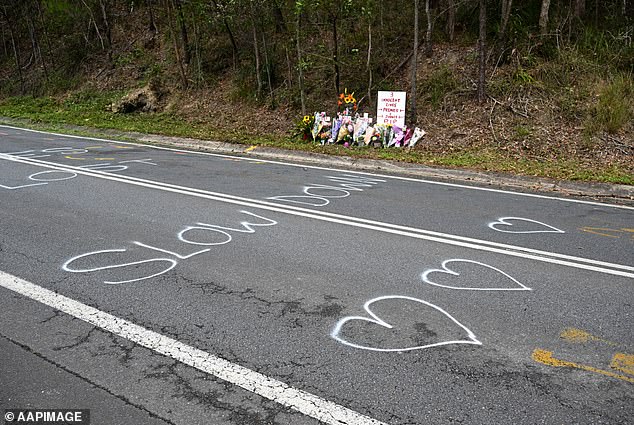 Police allege that Taufua was evading police when he collided with the family's car (in the photo, the tributes left at the scene of the accident)