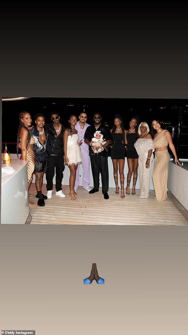 Family!  The music mogul proudly held his baby girl as he posed with his family.