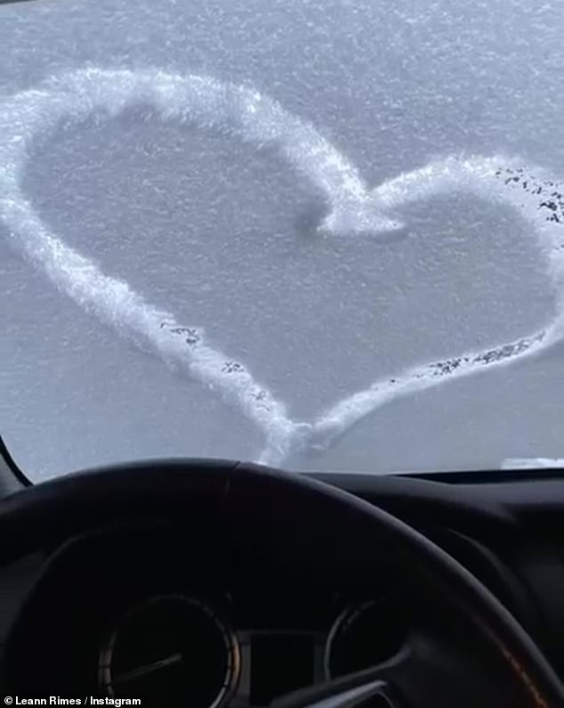 Romantic: In her post, LeAnn shared a sweet photo of a heart that her husband drew in the snow on the windshield of their car